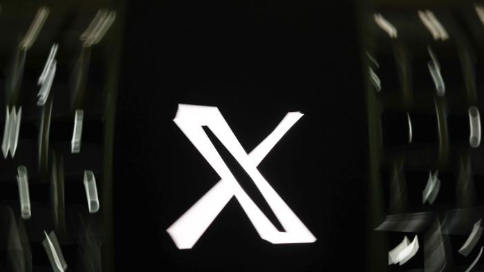 A laptop keyboard and X logo displayed on a phone screen are seen in this illustration photo taken in Krakow, Poland on September 2, 2024. (Photo by Jakub Porzycki/NurPhoto via Getty Images)